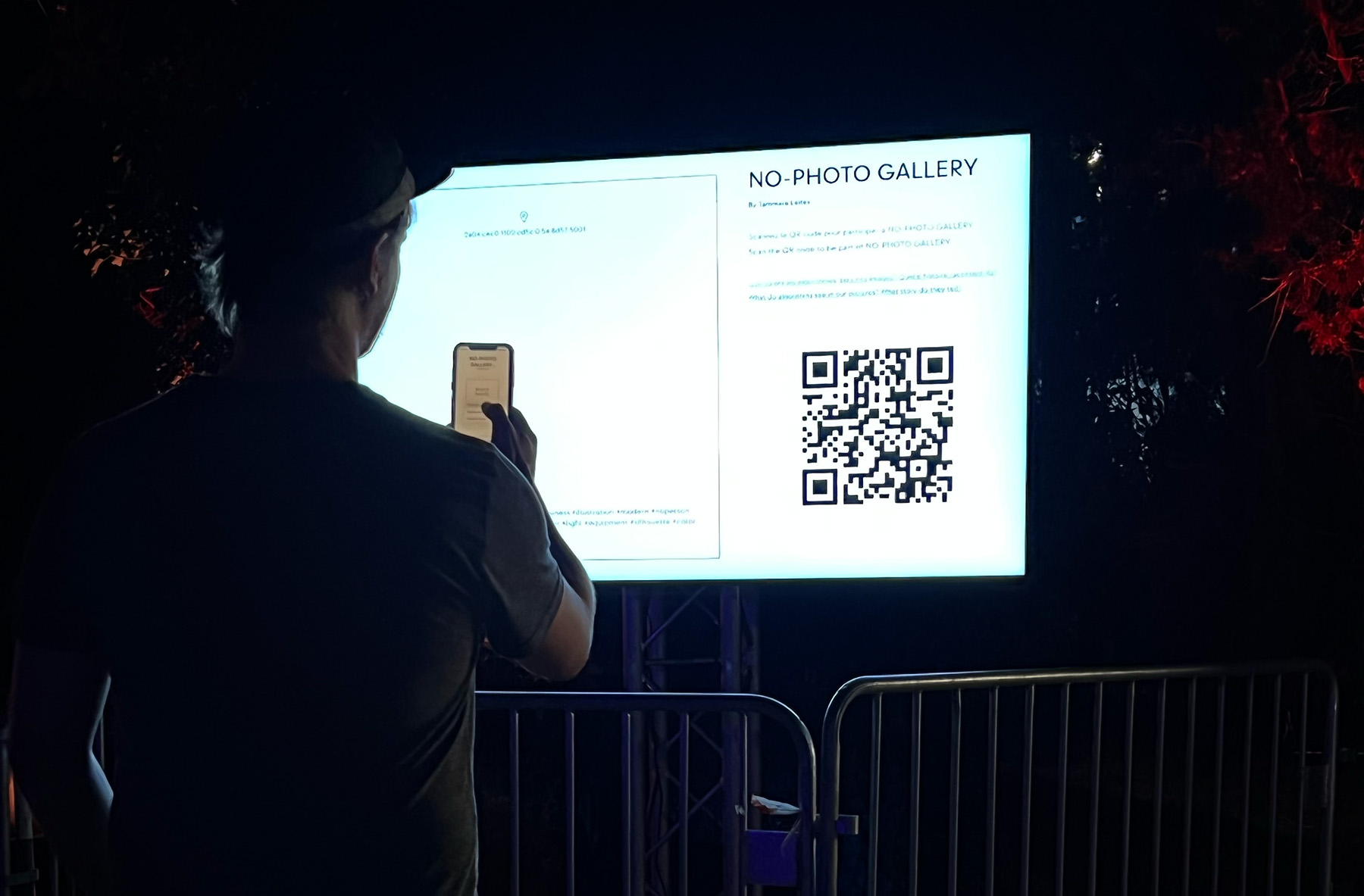 Visitor interacting with the NO-PHOTO GALLERY installation at Rencontres de la Photographie d'Arles.